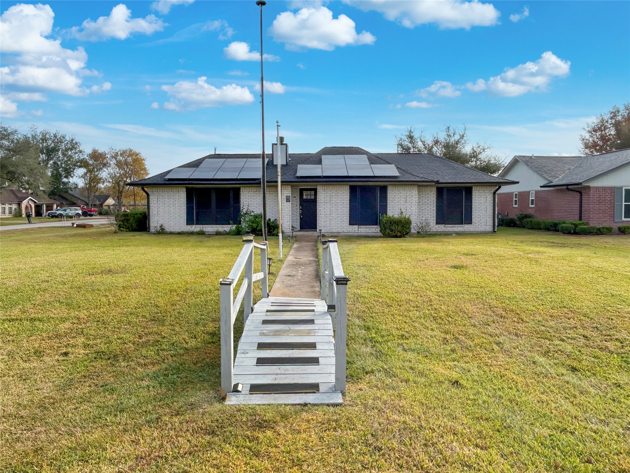 6132 Fox Ridge Drive Angleton, TX 77515 - Photo 26 of 28 a front view of a house with swimming pool and porch with furniture