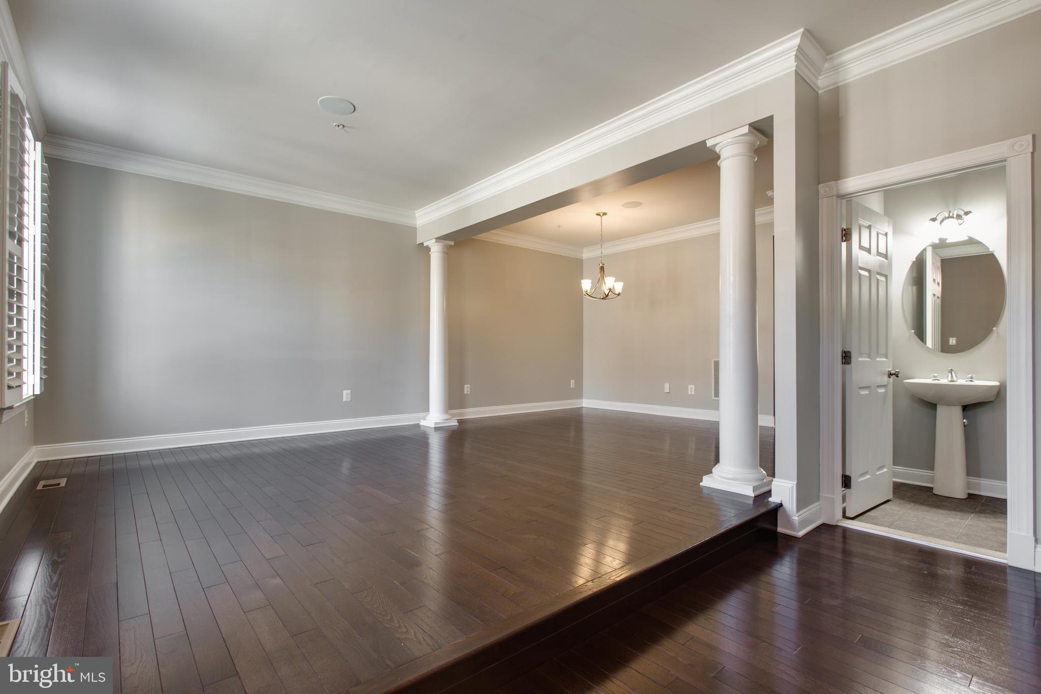 2265 Brimstone Place Hanover, MD 21076 - Photo 11 of 70 an empty room with wooden floor and mirror
