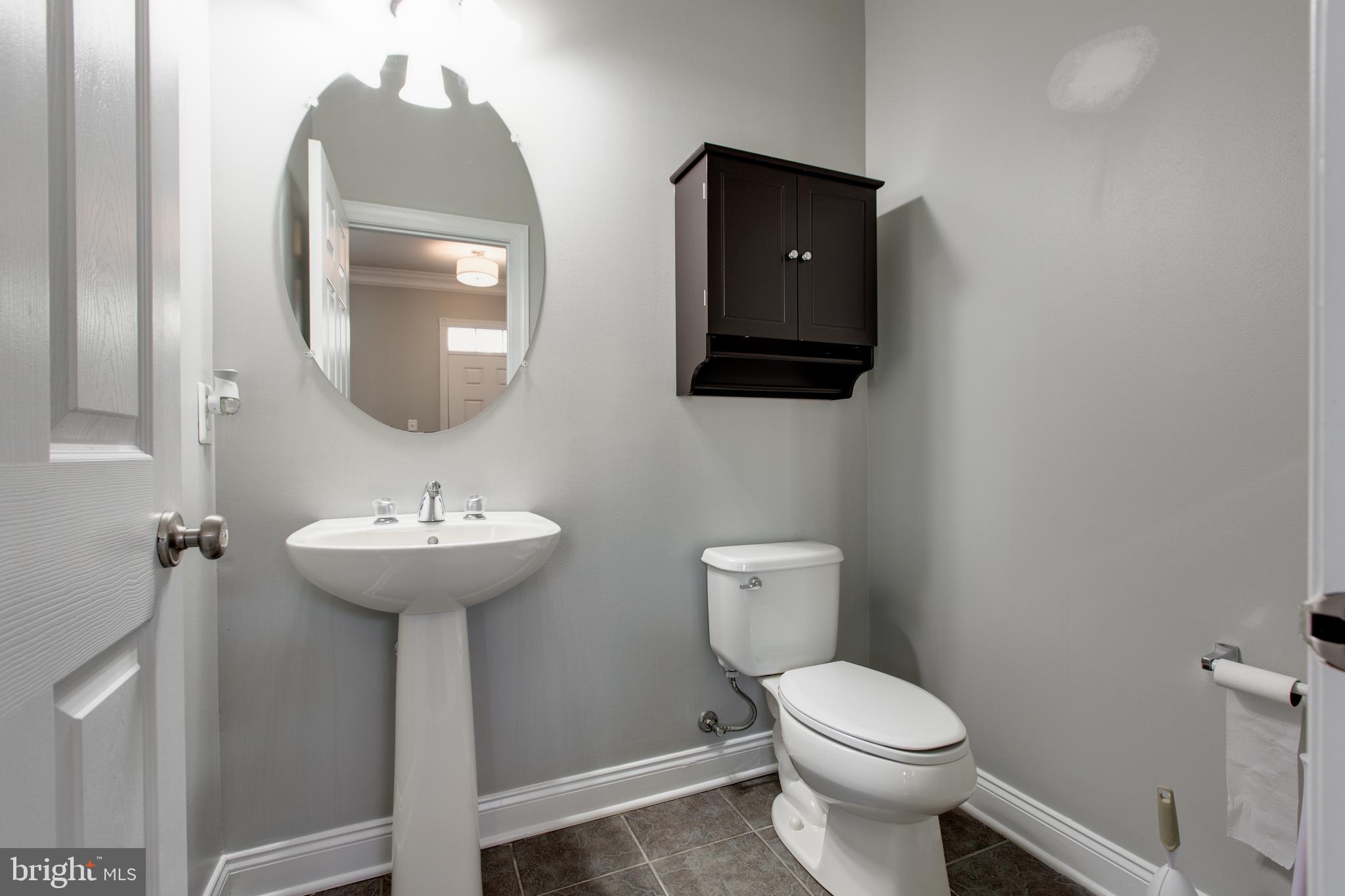 2265 Brimstone Place Hanover, MD 21076 - Photo 14 of 70 a bathroom with a toilet sink and mirror