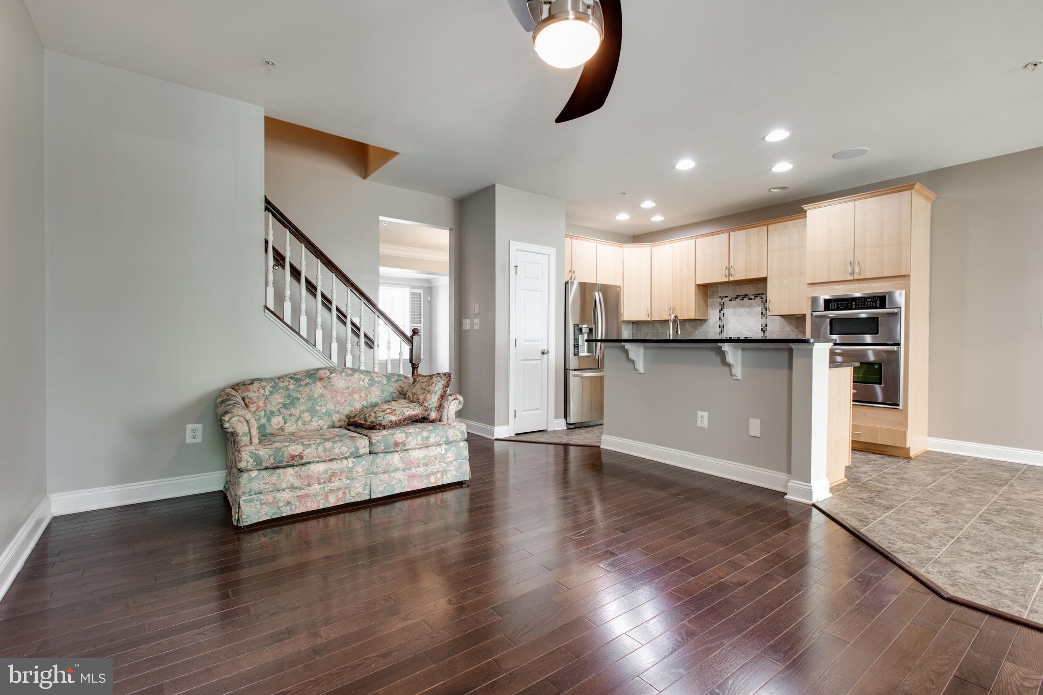 2265 Brimstone Place Hanover, MD 21076 - Photo 17 of 70 a living room with stainless steel appliances kitchen island hardwood floor and a view of kitchen