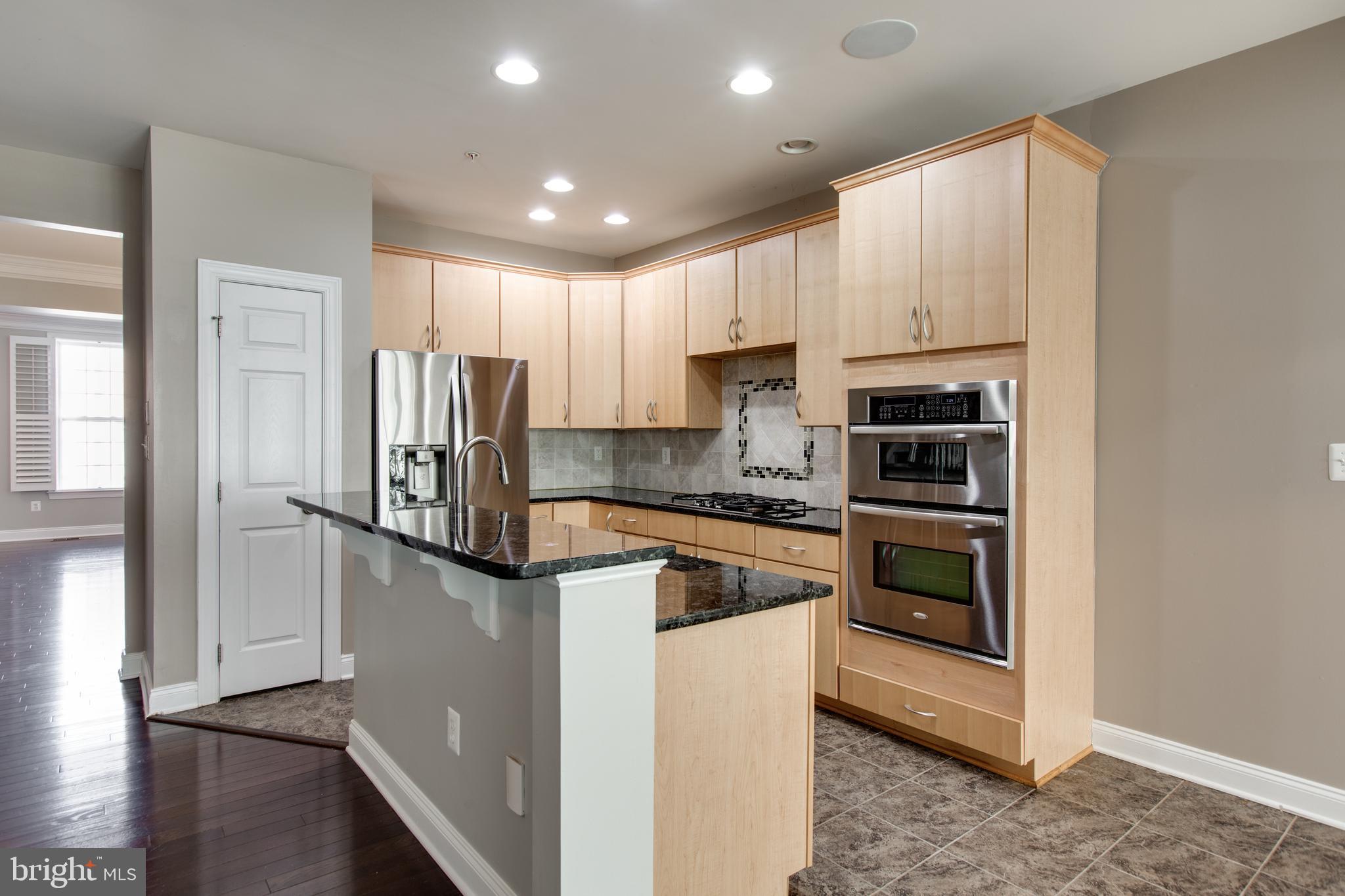 2265 Brimstone Place Hanover, MD 21076 - Photo 19 of 70 a kitchen with stainless steel appliances granite countertop a refrigerator a stove and a sink