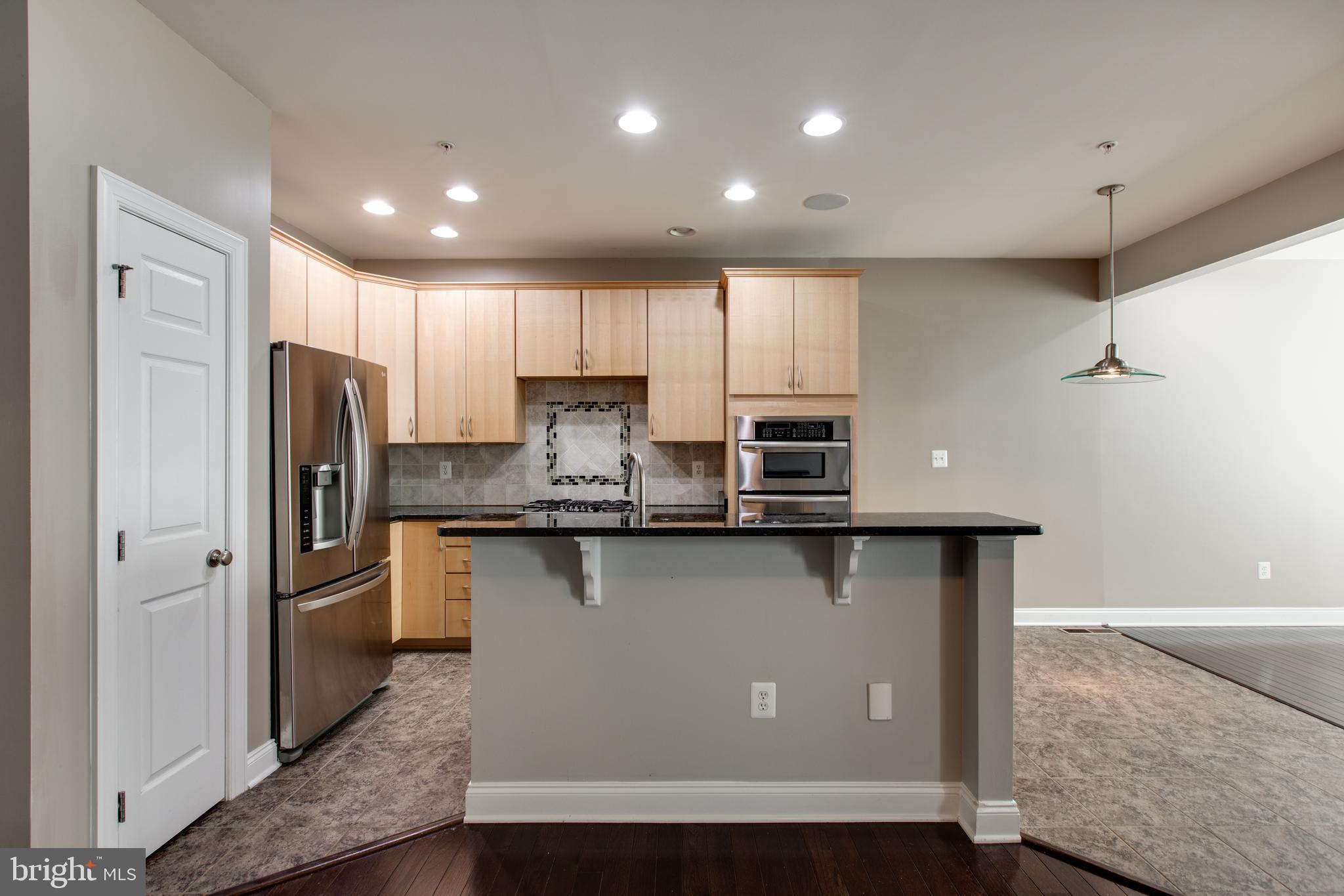 2265 Brimstone Place Hanover, MD 21076 - Photo 21 of 70 a kitchen with stainless steel appliances granite countertop a refrigerator a sink and a stove