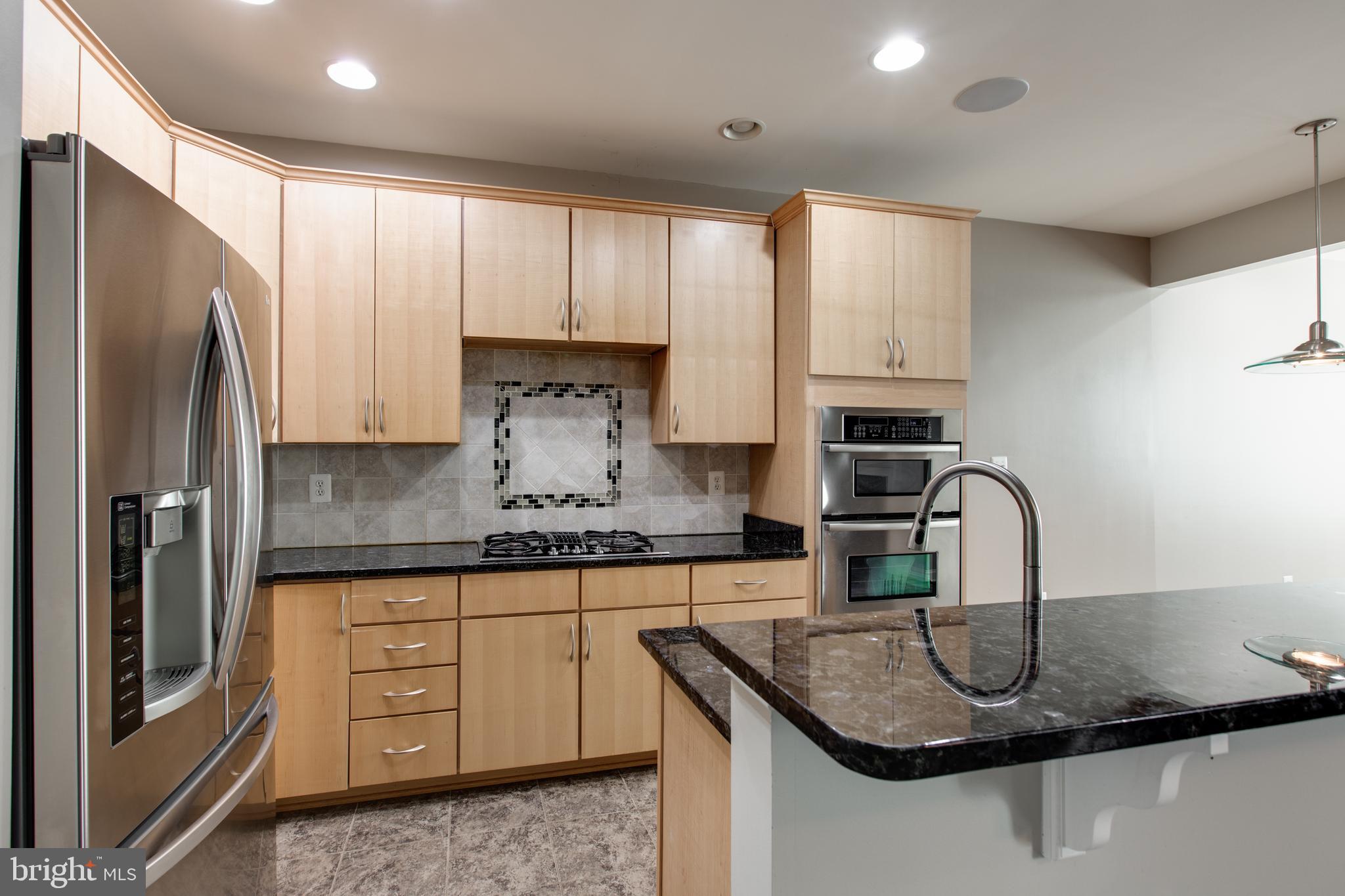 2265 Brimstone Place Hanover, MD 21076 - Photo 22 of 70 a kitchen with stainless steel appliances granite countertop a sink refrigerator and cabinets