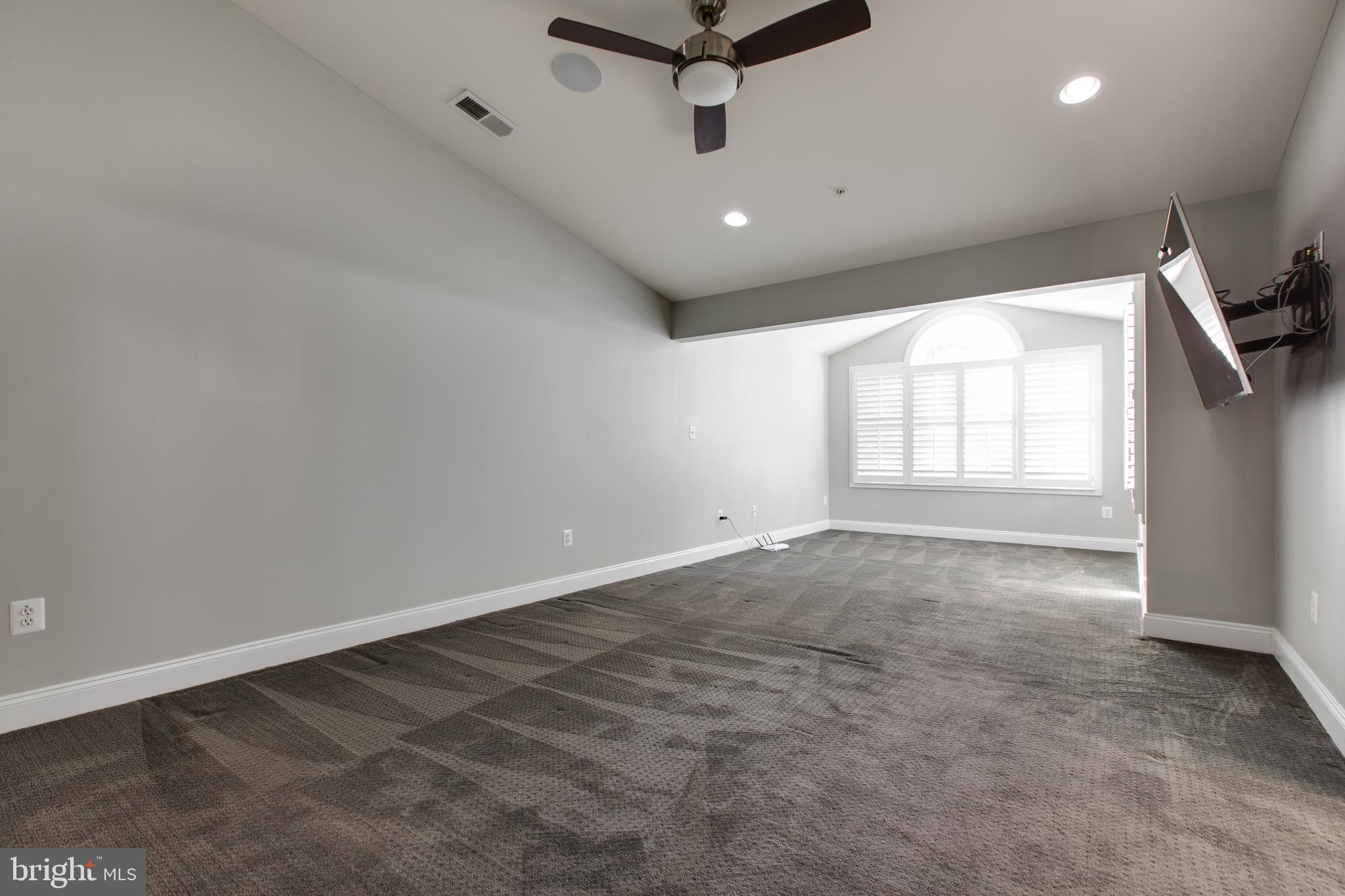 2265 Brimstone Place Hanover, MD 21076 - Photo 29 of 70 an empty room with windows and ceiling fan