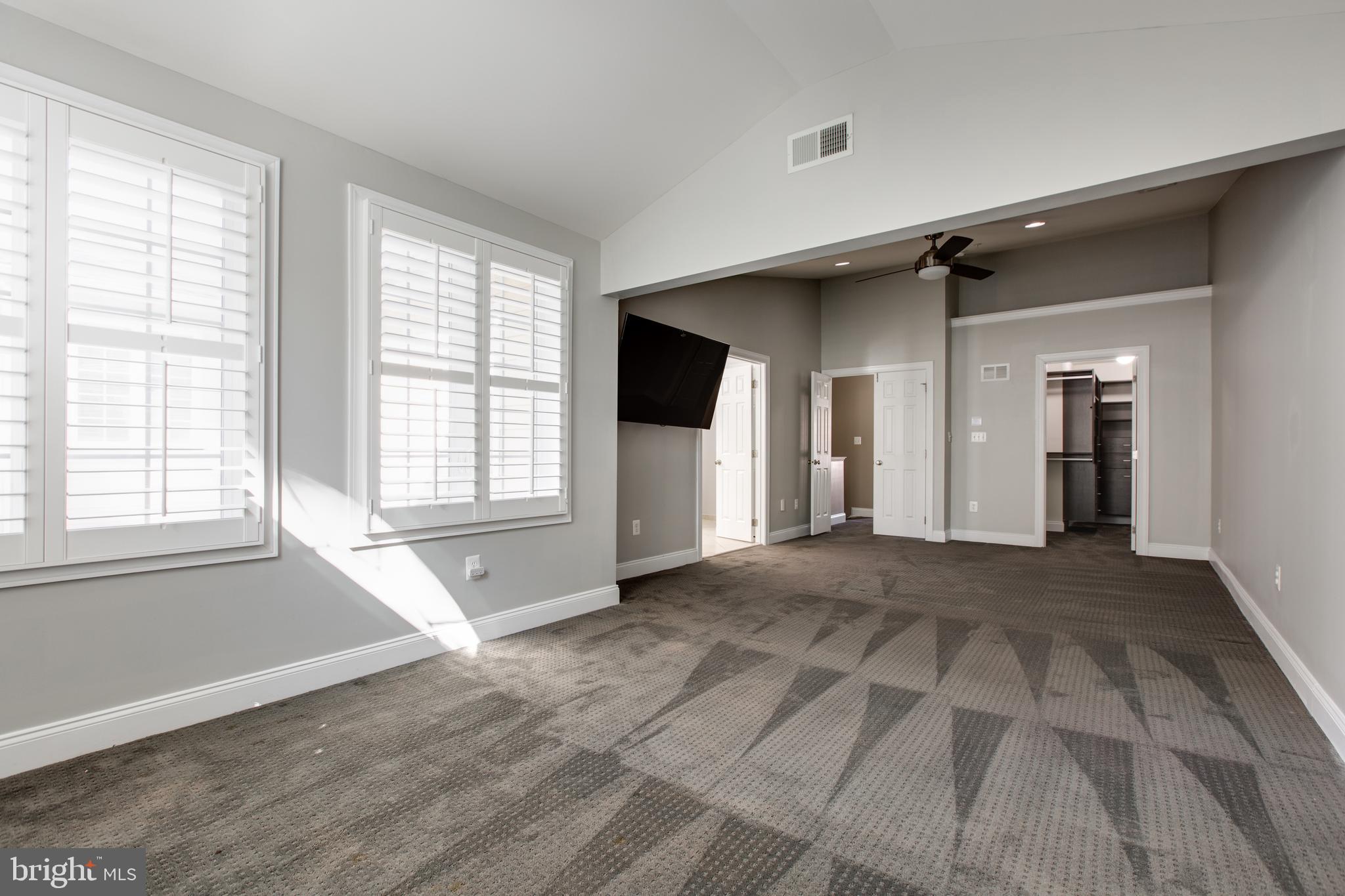 2265 Brimstone Place Hanover, MD 21076 - Photo 32 of 70 a view of an empty room with a window and a kitchen