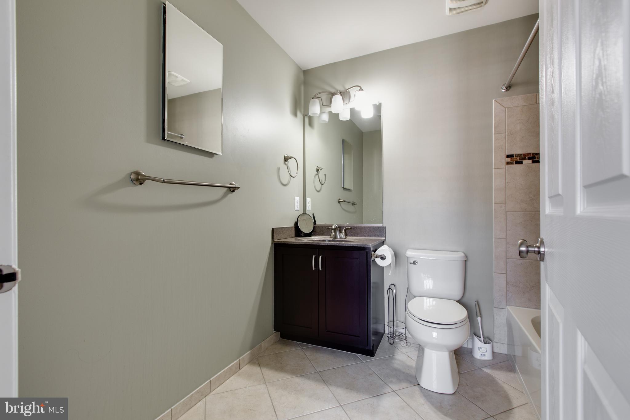 2265 Brimstone Place Hanover, MD 21076 - Photo 35 of 70 a bathroom with a toilet a sink and mirror