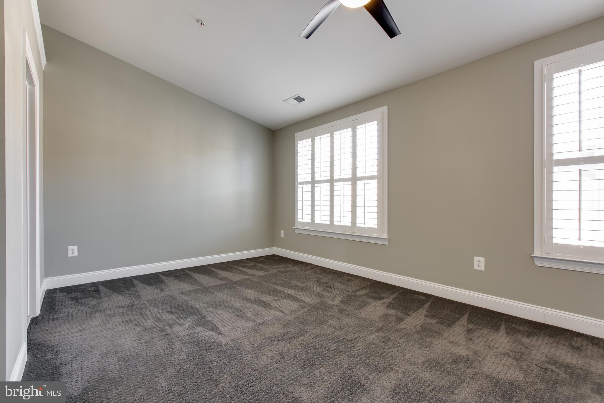 2265 Brimstone Place Hanover, MD 21076 - Photo 39 of 70 an empty room with windows and ceiling fan