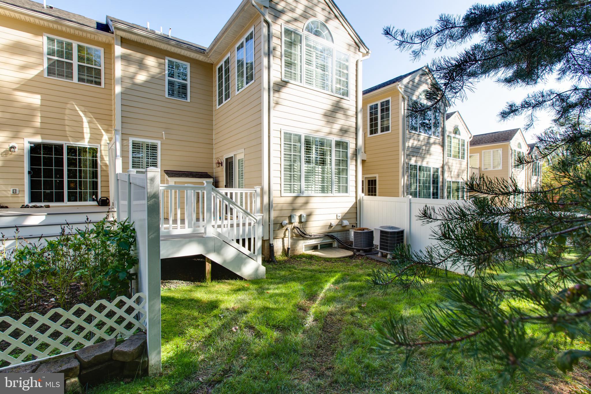 2265 Brimstone Place Hanover, MD 21076 - Photo 46 of 70 a front view of a house with a yard table and chairs