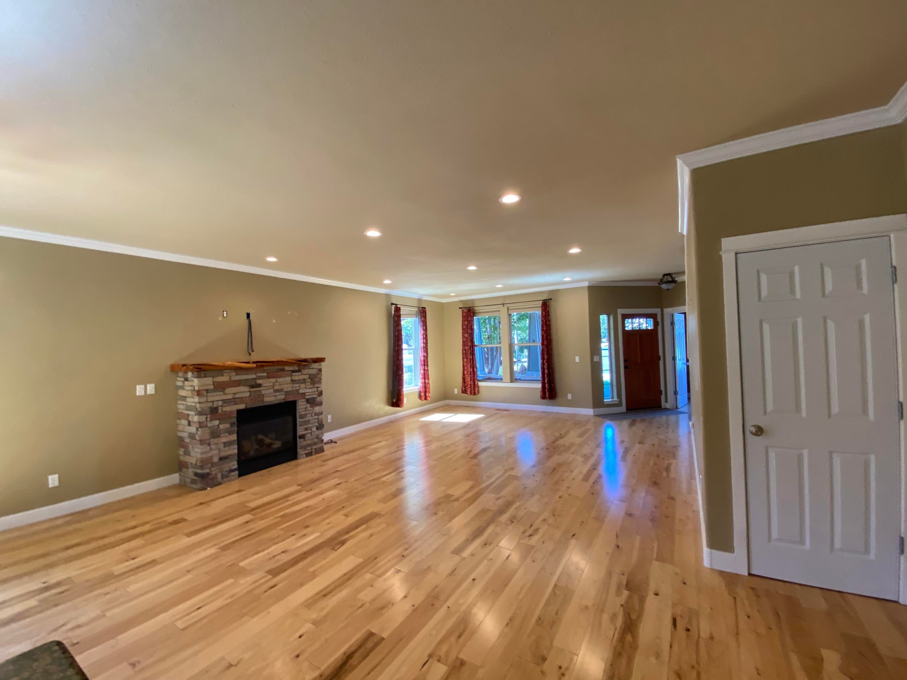 1216 Southwest Rimrock Way Redmond, OR 97756 - Photo 4 of 7 The living room is bright and open, with gorgeous paint and beautiful wood floors