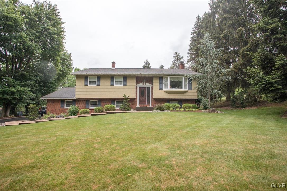 a view of a house with pool and chairs