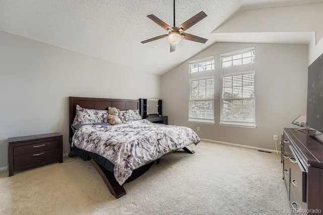 a bedroom with a bed dresser and a window