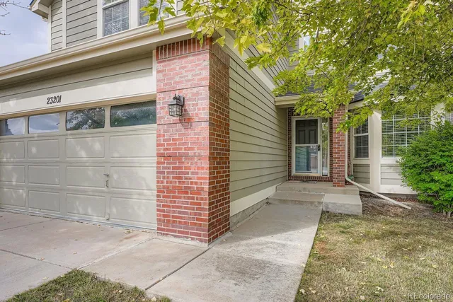 a view of a house with a door and wooden walls