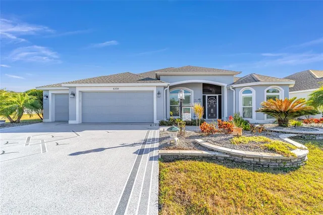 a view of a house with swimming pool and sitting area