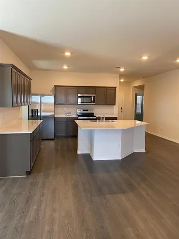 a large kitchen with stainless steel appliances lots of counter top space