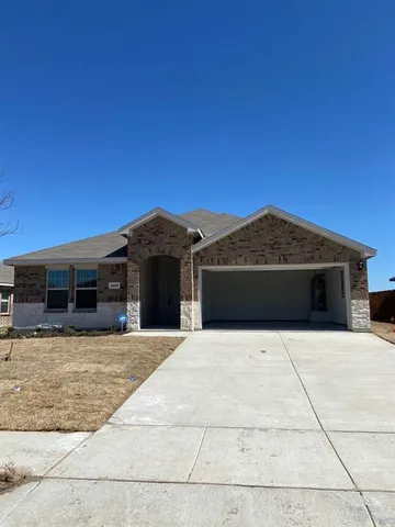 a front view of a house with yard