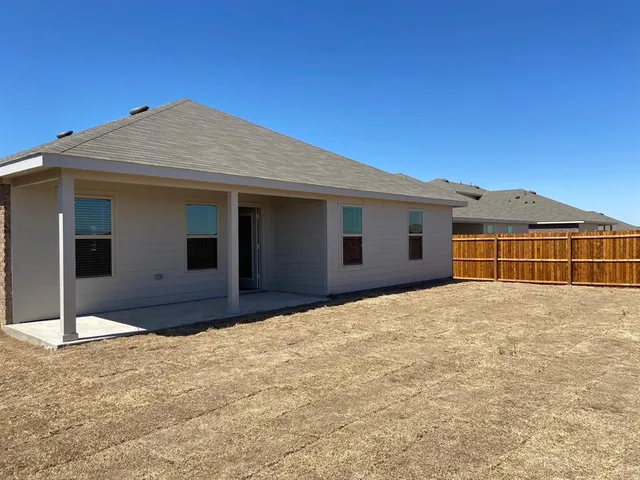 a big house with large windows and a yard