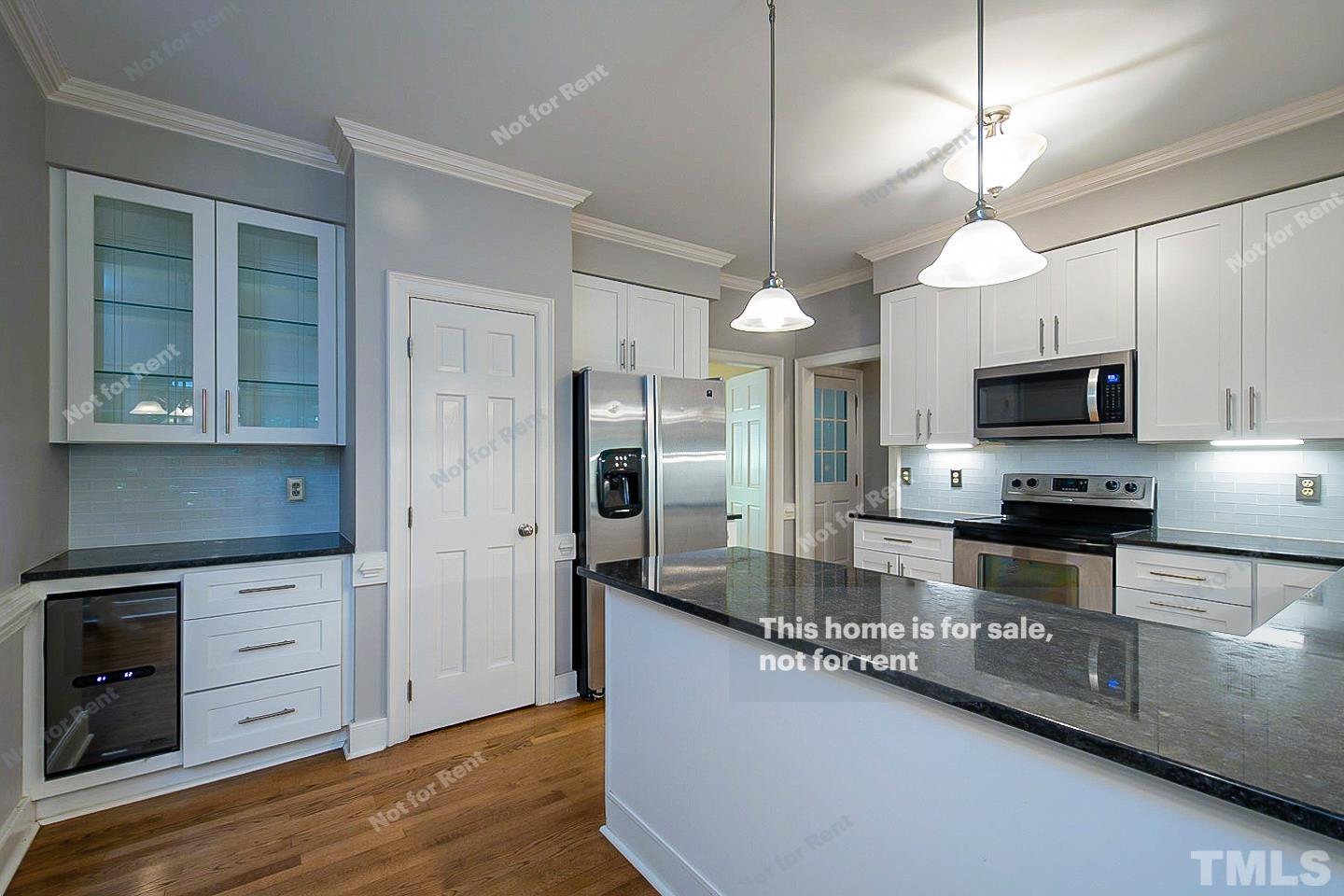 7904 Farnham Court Raleigh, NC 27615 - Photo 8 of 23 a kitchen with stainless steel appliances granite countertop a sink a stove and a refrigerator