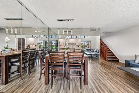 a dining room with furniture entryway and wooden floor