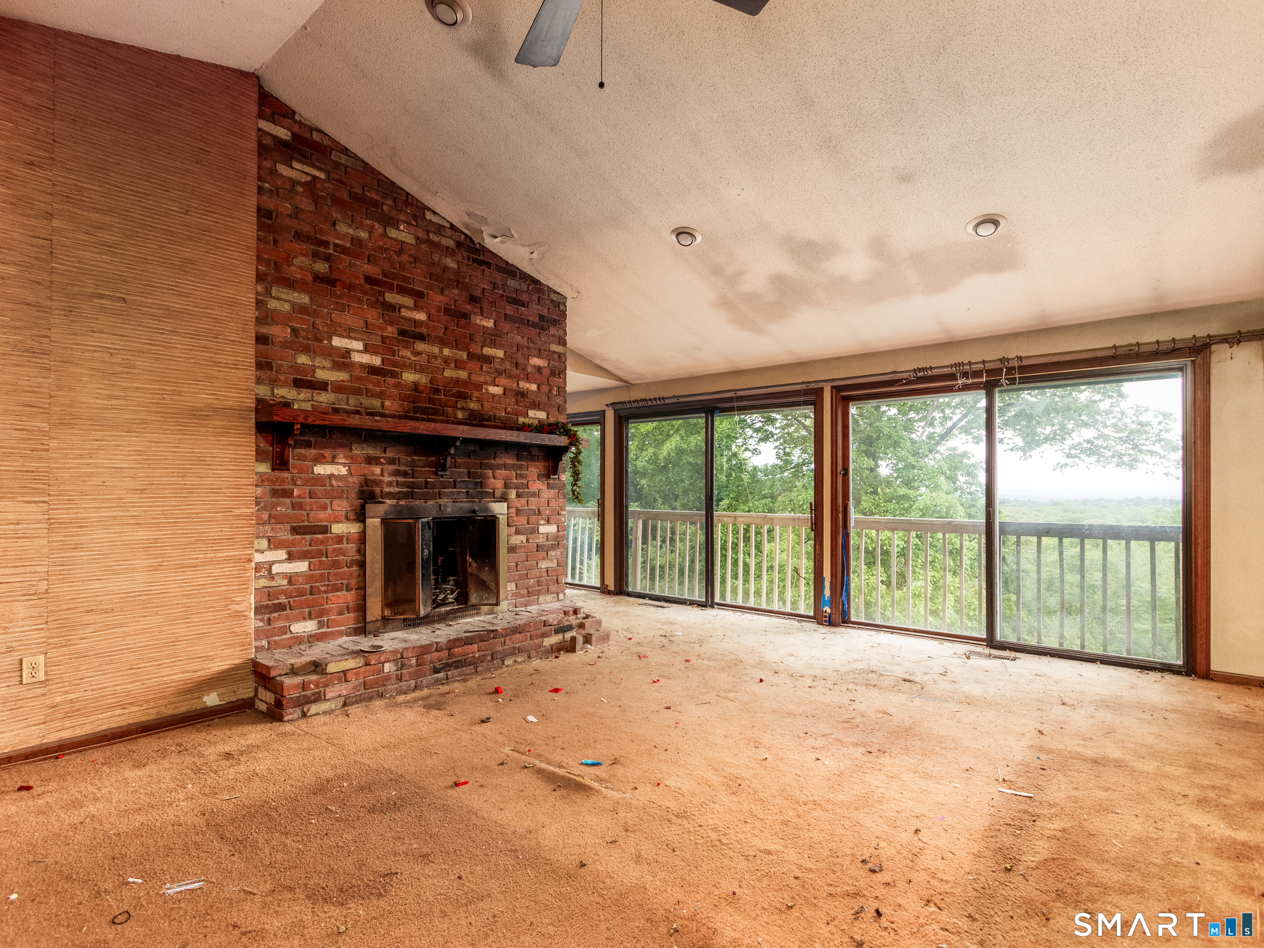 63 High Hill Road Wallingford, CT 06492 - Photo 17 of 34 a view of an empty room with a fireplace and a large window