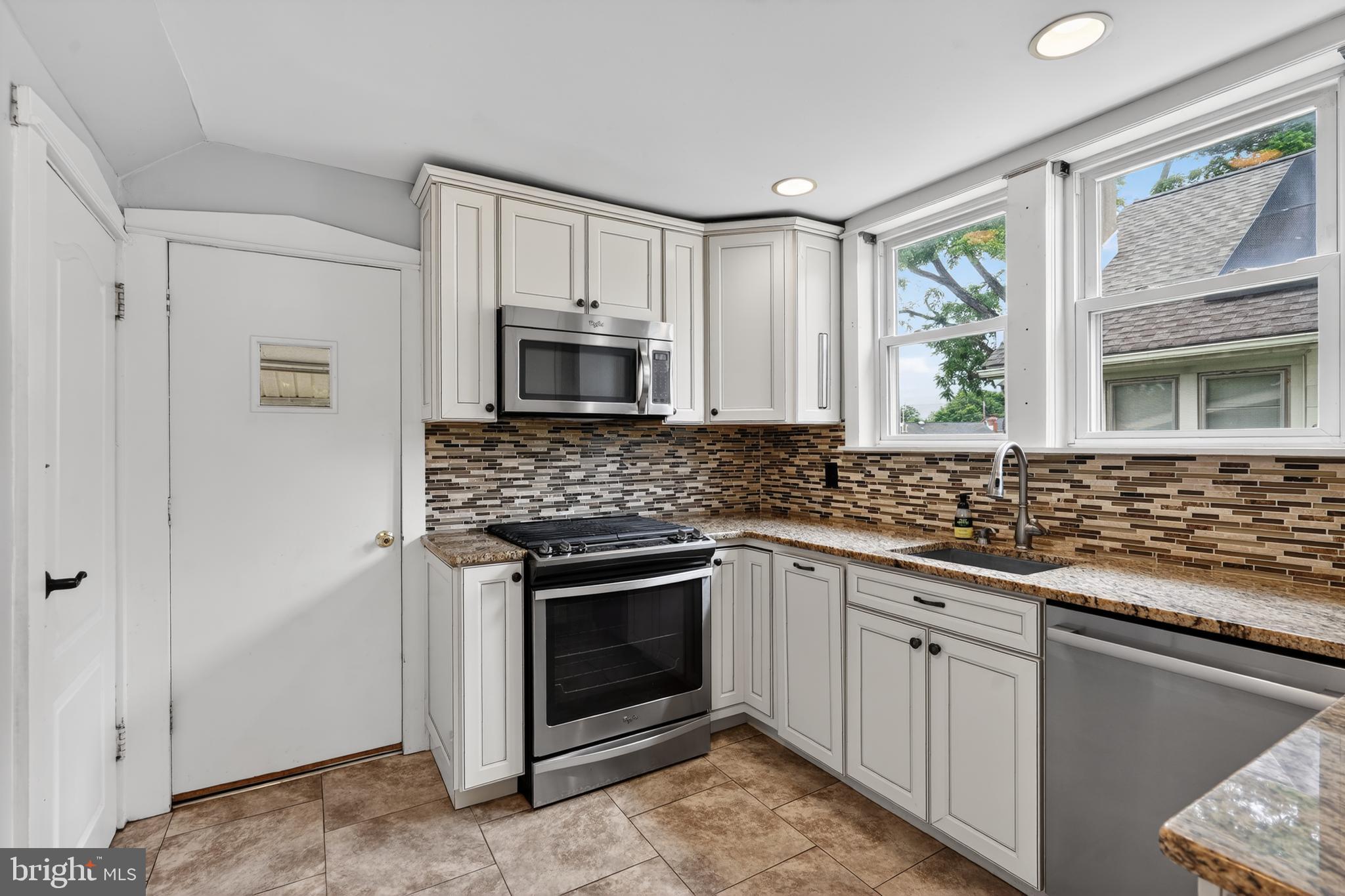 106 Ford Street Voorhees, NJ 08043 - Photo 17 of 36 a kitchen with stainless steel appliances granite countertop white cabinets granite counter tops and a window