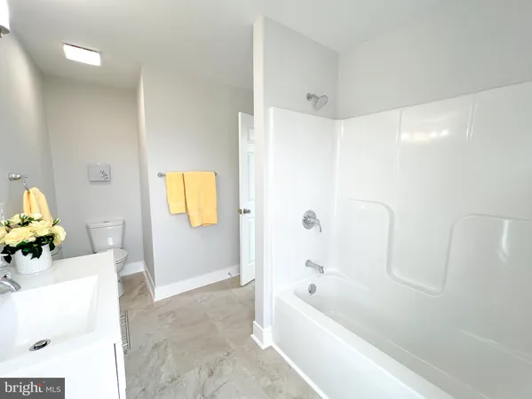 a bathroom with a bathtub a window and a tub