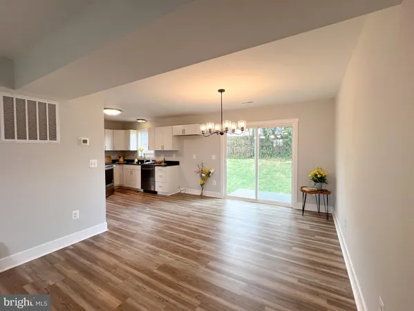 a view of a living room and kitchen with furniture wooden floor and window