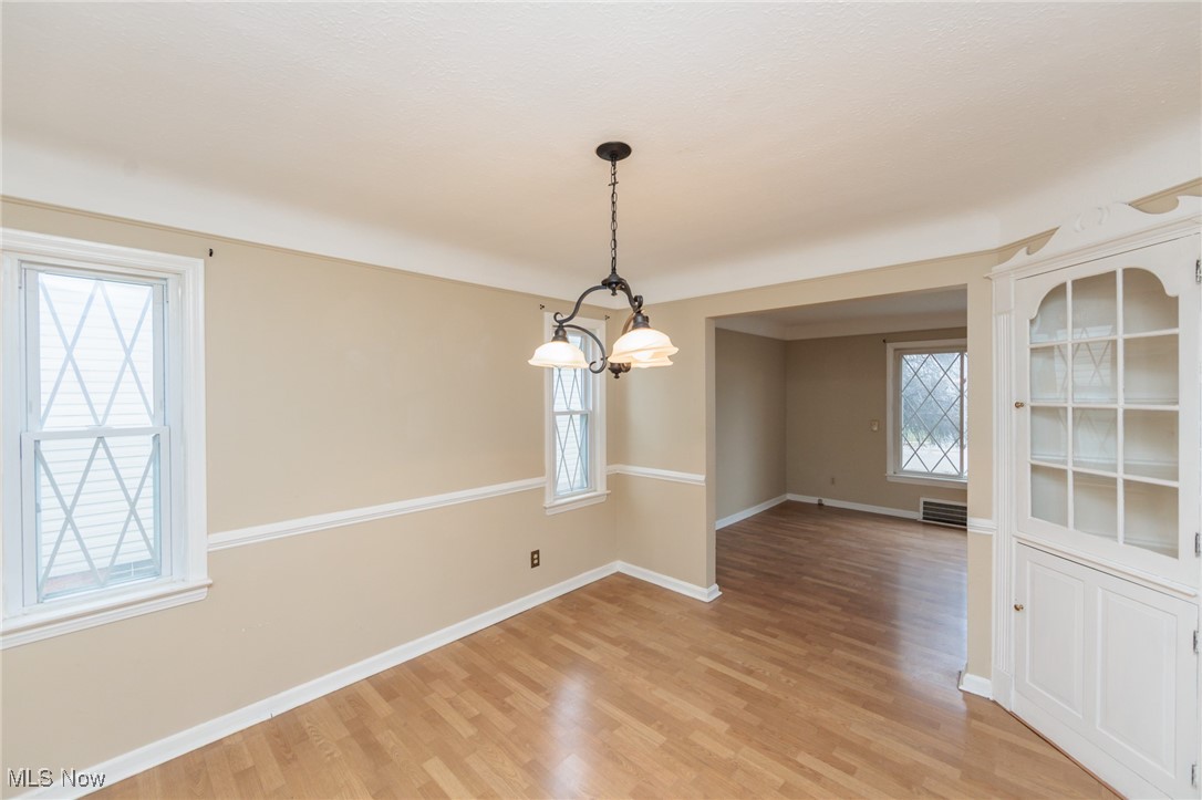 1232 Avondale Road Cleveland, OH 44121 - Photo 10 of 46 Unfurnished dining area with light wood-type flooring, visible vents, and baseboards