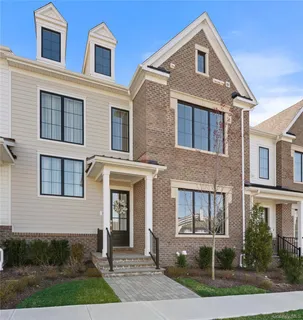 a front view of a house with garden and porch
