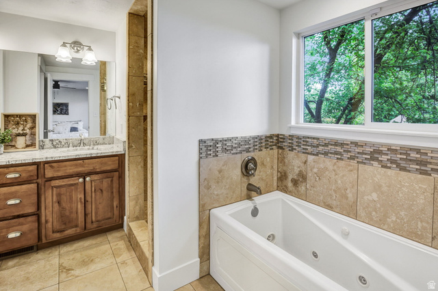 1320 Canyon Park Road Bountiful, UT 84010 - Photo 13 of 28 Ensuite bathroom with vanity, a jetted tub, light tile patterned floors, and tiled shower
