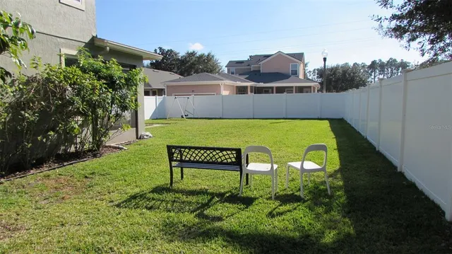 a view of a chairs in a backyard