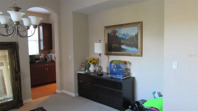 a bedroom with a bed and a mirror on dresser