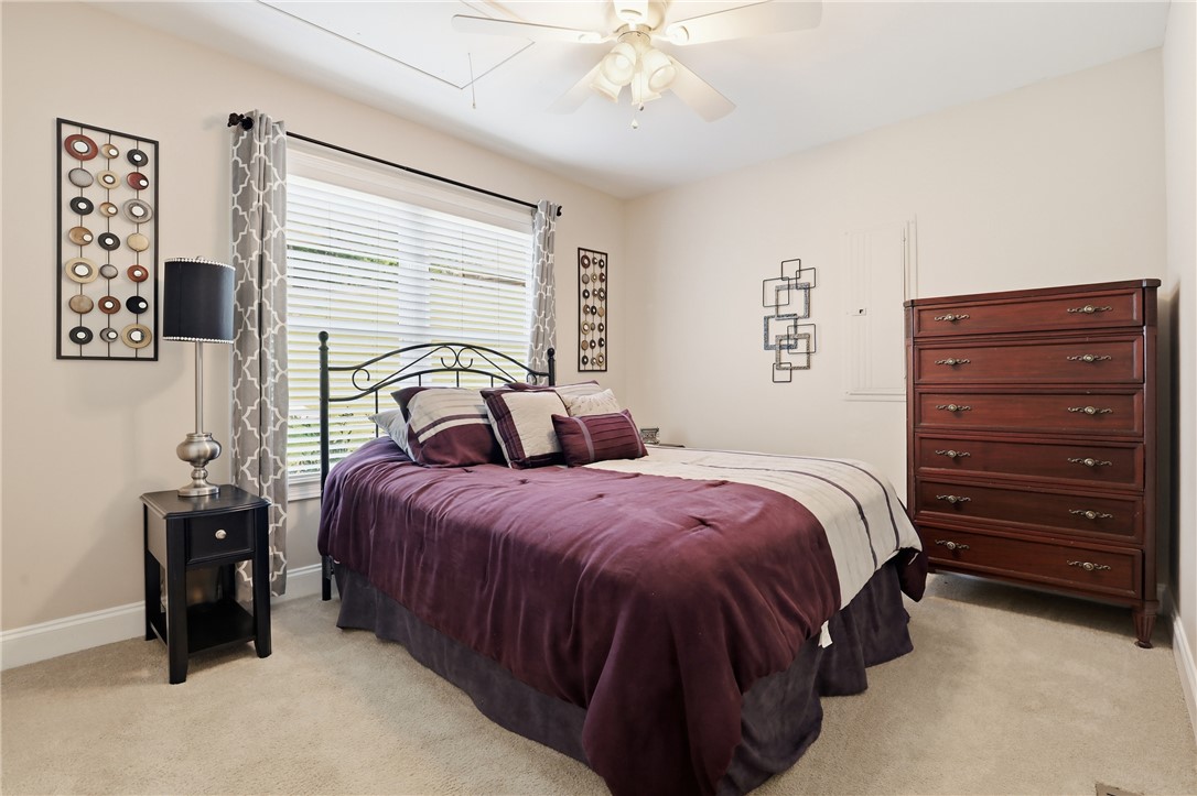 1110 Sunset Lane Anderson, SC 29626 - Photo 14 of 38 A well-lit bedroom features plush carpeting and a cooling ceiling fan.