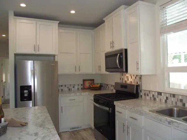 a view of a room with workspace and a window