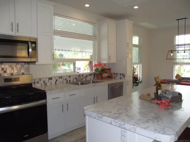 a view of a backyard with chairs and a flower plants