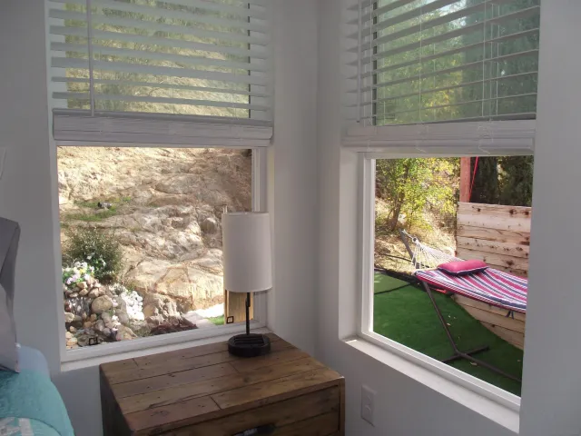 a front view of a house with a yard and large trees