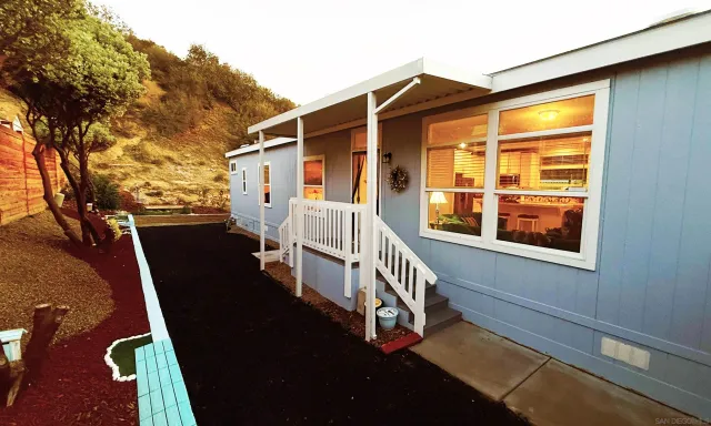 a living room with furniture a lamp and a table