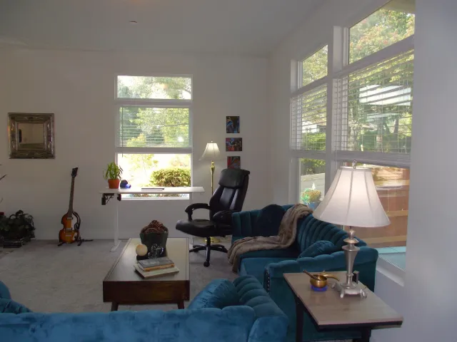 a view of a hallway with dining table and chairs