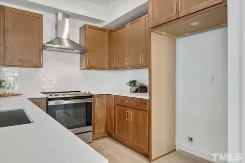 a kitchen with granite countertop a stove and a sink