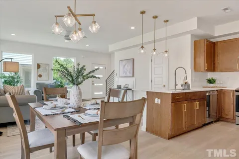 a kitchen with a table and chairs in it