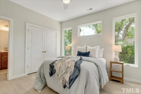 a bed room with a bed and a window