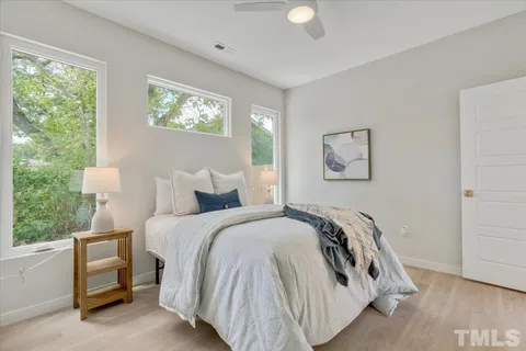 a bed sitting in a bedroom next to a window