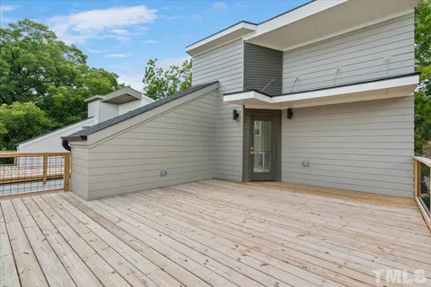 a view of a house with a wooden deck