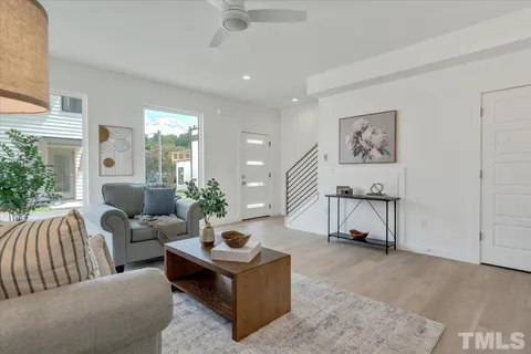 a living room with furniture and a painting on the wall