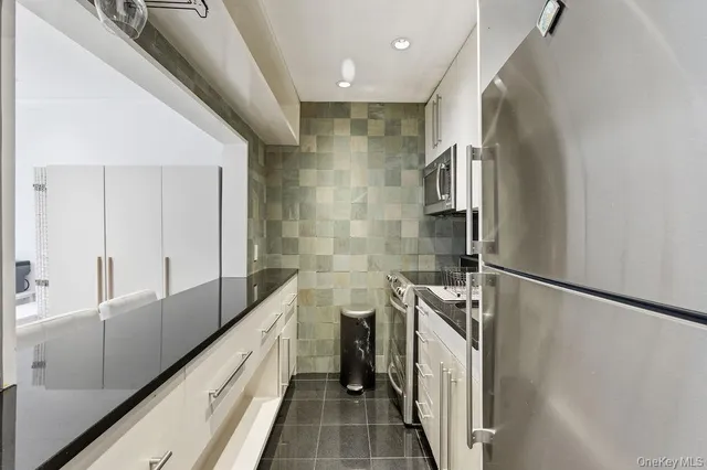 a kitchen with a refrigerator and a sink