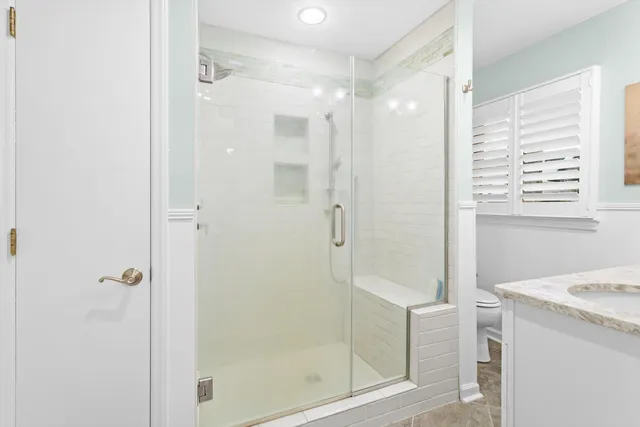 a bathroom with a shower and a sink