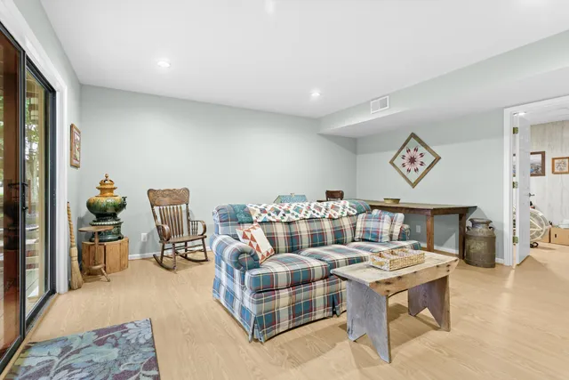 a living room with furniture a rug and a table