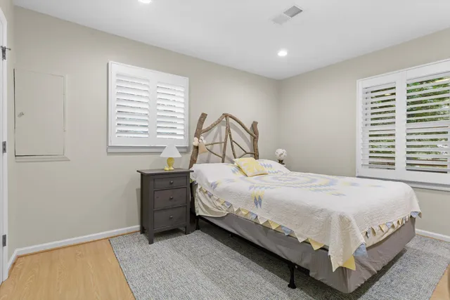 a large bed sitting in a bedroom next to a window and dresser