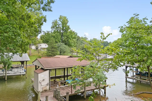 a aerial view of a house with swimming pool table and chairs