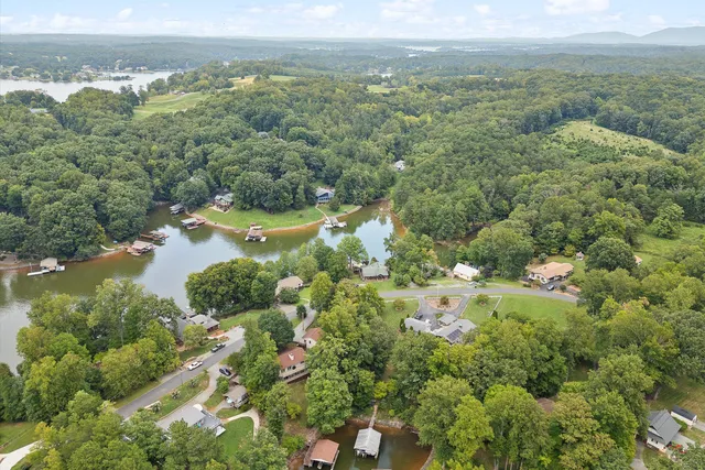 an aerial view of a houses with a yard