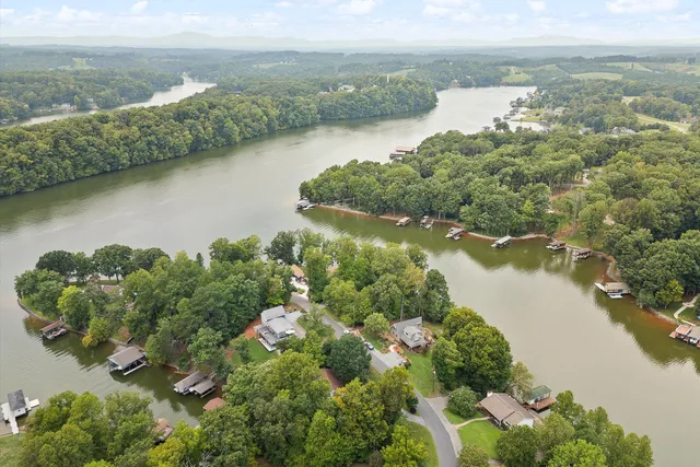 an aerial view of a houses with a lake view